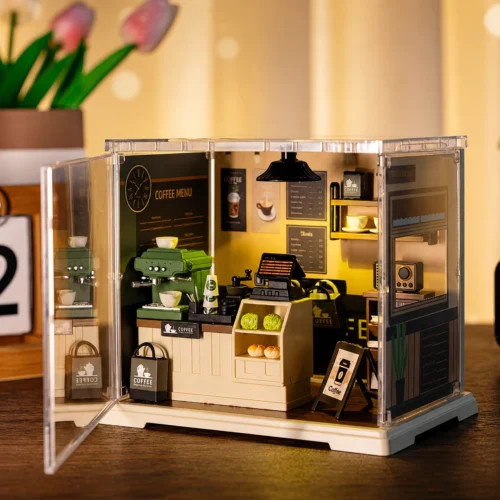 Miniature coffee shop DIY kit with detailed café counter, coffee machine, shelves, cups and cozy interior décor