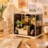 Miniature coffee shop DIY kit with detailed café counter, coffee machine, shelves, cups and cozy interior décor