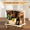 Miniature coffee shop DIY kit with detailed café counter, coffee machine, shelves, cups and cozy interior décor