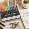 12 Colors Outline Marker Set with metallic double-line pens in a clear storage case for lettering, journaling, greeting cards, and DIY crafts. 12 Colors Outline Marker Set with metallic double-line pens in a clear storage case for lettering, journaling, greeting cards, and DIY crafts.