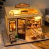 Miniature DIY bakery house kit with warm lighting, tiny pastries, shelves and cozy bakery decor