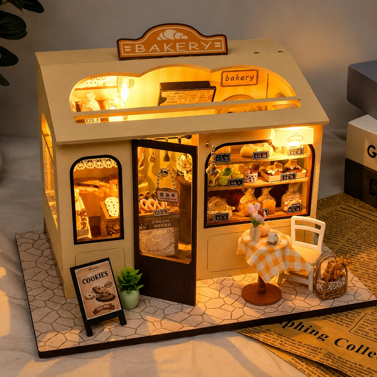 Miniature DIY bakery house kit with warm lighting, tiny pastries, shelves and cozy bakery decor