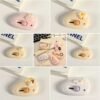 Cute mini cutter with pastel kawaii design held in hand beside a white keyboard