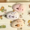 Cute mini cutter with pastel kawaii design held in hand beside a white keyboard