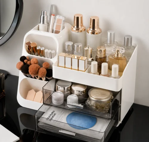 Multi-compartment desk organizer with drawers holding notebooks, pens, markers, scissors, stationery and craft supplies