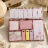 Kawaii floral weekly planner sticky notes set with memo pads, page markers, to-do list, and pastel stationery arranged on a wooden desk. Kawaii floral weekly planner sticky notes set with memo pads, page markers, to-do list, and pastel stationery arranged on a wooden desk.