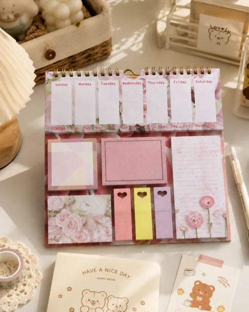 Kawaii floral weekly planner sticky notes set with memo pads, page markers, to-do list, and pastel stationery arranged on a wooden desk. Kawaii floral weekly planner sticky notes set with memo pads, page markers, to-do list, and pastel stationery arranged on a wooden desk.