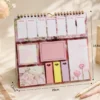 Kawaii floral weekly planner sticky notes set with memo pads, page markers, to-do list, and pastel stationery arranged on a wooden desk. Kawaii floral weekly planner sticky notes set with memo pads, page markers, to-do list, and pastel stationery arranged on a wooden desk.