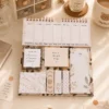 Minimalist Marble Weekly Planner Sticky Notes Set with memo pads, page markers, and weekly planner on a wooden desk. Minimalist Marble Weekly Planner Sticky Notes Set with memo pads, page markers, and weekly planner on a wooden desk.
