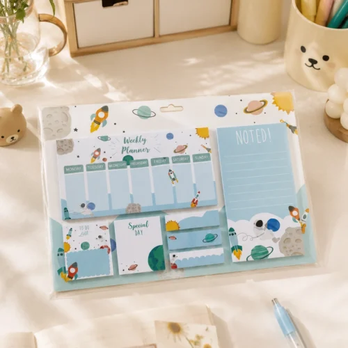Space Weekly Planner Sticky Notes Set with rockets, planets, weekly planner, memo pads, sticky notes, page markers, and to-do list on a wooden desk. Space Weekly Planner Sticky Notes Set with rockets, planets, weekly planner, memo pads, sticky notes, page markers, and to-do list on a wooden desk.