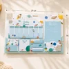 Space Weekly Planner Sticky Notes Set with rockets, planets, weekly planner, memo pads, sticky notes, page markers, and to-do list on a wooden desk.