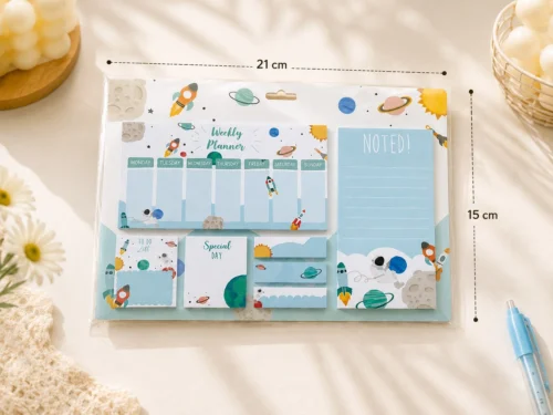 Space Weekly Planner Sticky Notes Set with rockets, planets, weekly planner, memo pads, sticky notes, page markers, and to-do list on a wooden desk.