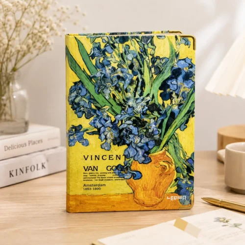 Van Gogh notebook with blue iris floral artwork on a yellow hardcover