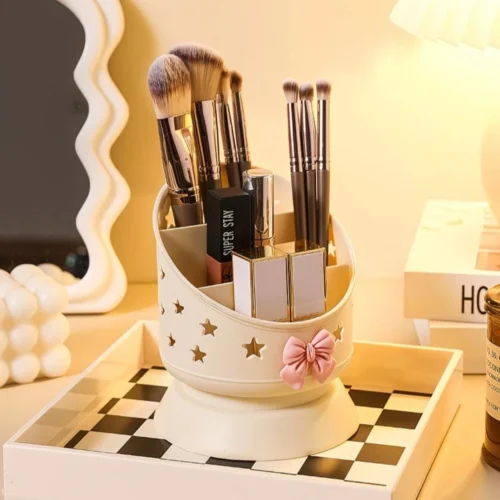 Cute desk organizer with pink bow and star cutouts holding pens and makeup brushes