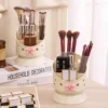 Cute desk organizer with pink bow and star cutouts holding pens and makeup brushes Cute desk organizer with pink bow and star cutouts holding pens and makeup brushes