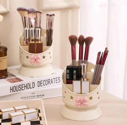 Cute desk organizer with pink bow and star cutouts holding pens and makeup brushes Cute desk organizer with pink bow and star cutouts holding pens and makeup brushes
