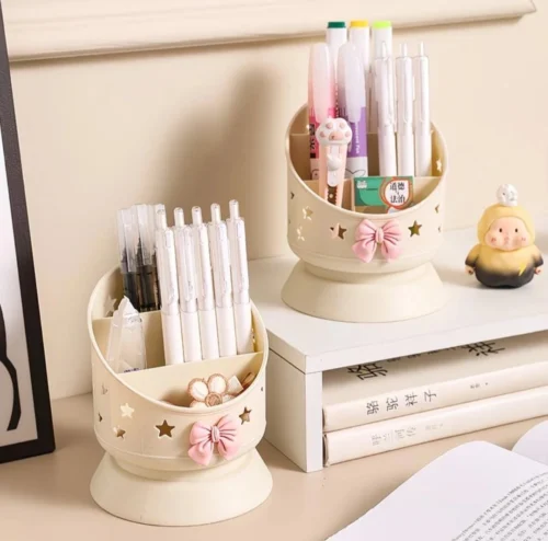 Cute desk organizer with pink bow and star cutouts holding pens and makeup brushes Cute desk organizer with pink bow and star cutouts holding pens and makeup brushes
