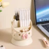 Cute desk organizer with pink bow and star cutouts holding pens and makeup brushes Cute desk organizer with pink bow and star cutouts holding pens and makeup brushes