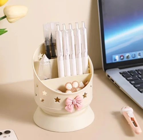 Cute desk organizer with pink bow and star cutouts holding pens and makeup brushes Cute desk organizer with pink bow and star cutouts holding pens and makeup brushes
